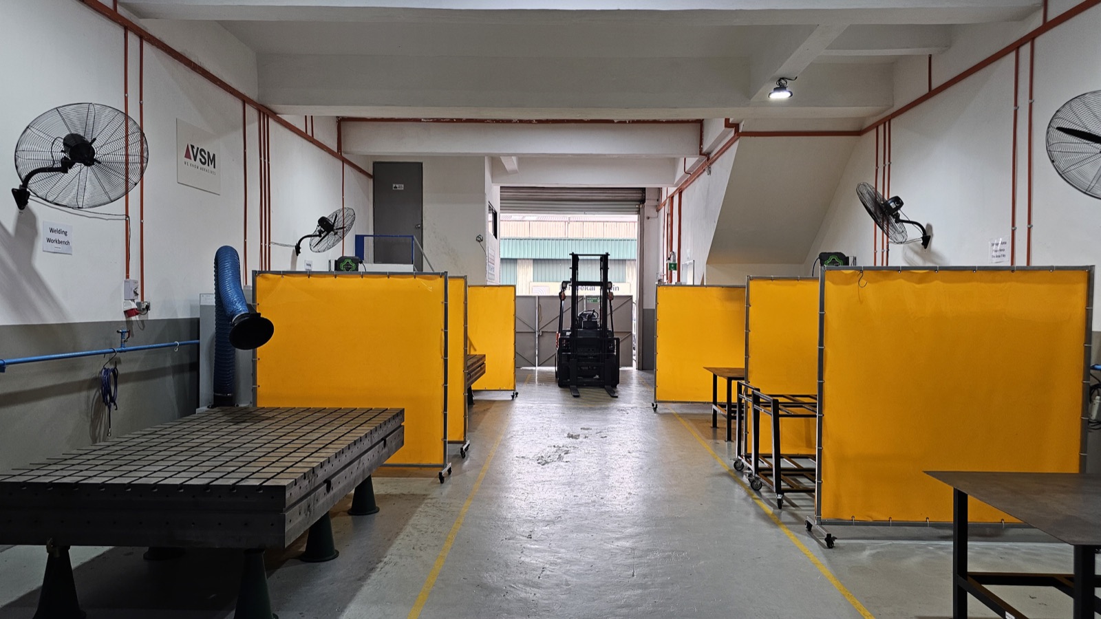 KLH workshop aisle and welding workstations